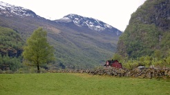 Field, Farmhouse, and Mountain in Lunden, Norway