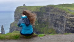 Haley sitting on the edge of the Cliffs of Moher
